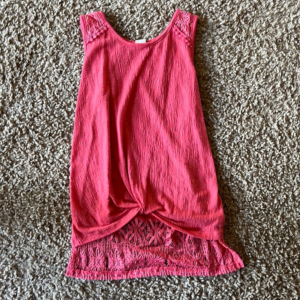 Pink tank top, shorter front and a longer back